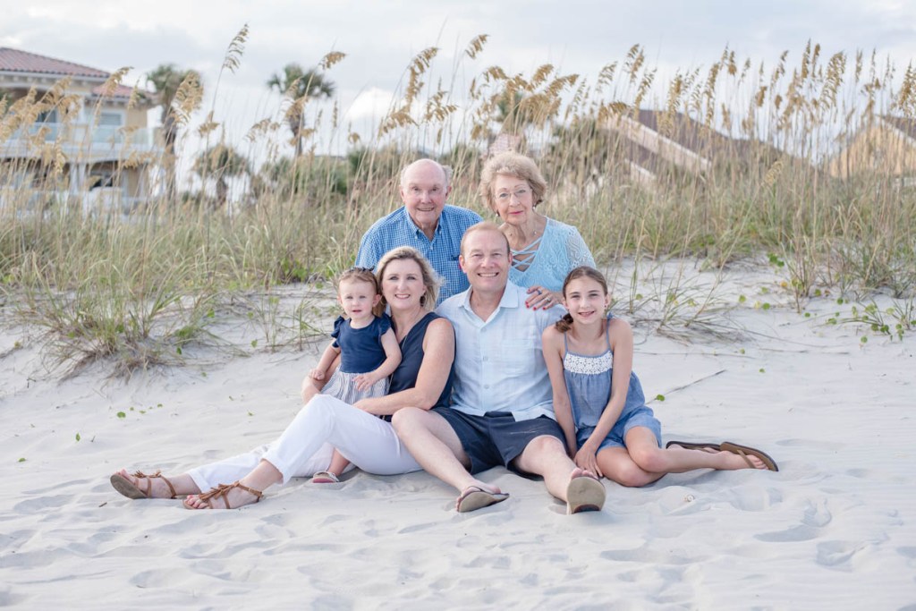 Family portrait at the beach sitting in the dunes